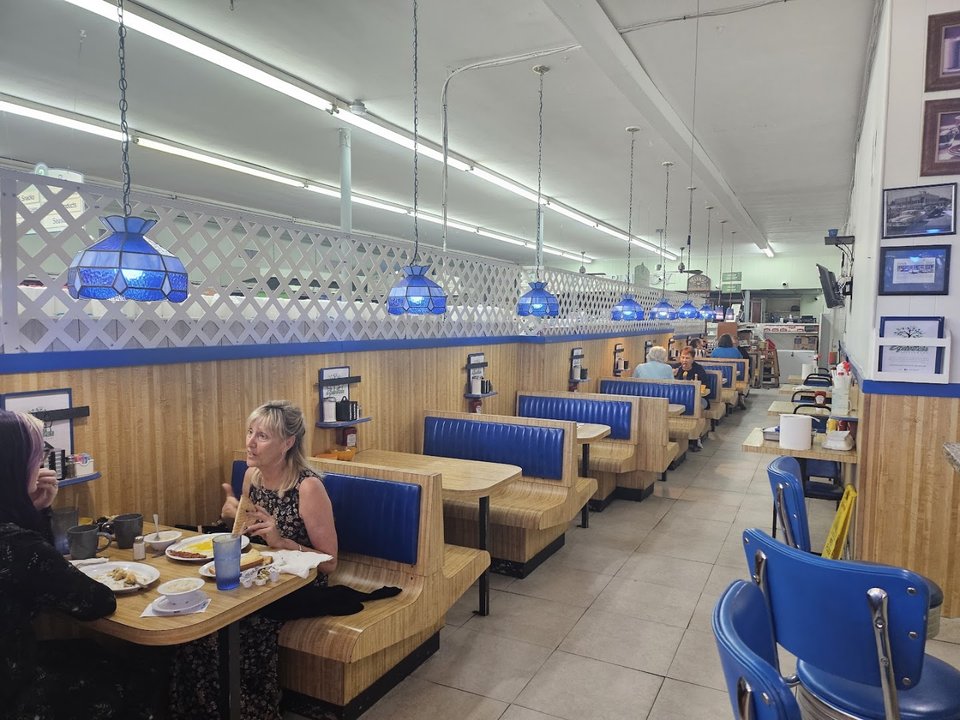 Quiet diner space with booths and chairs.